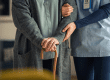 Closeup of hands of nurse with senior adult walking with cane