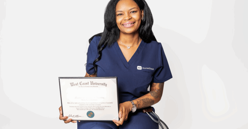 Nurse in blue scrubs holding graduation diploma